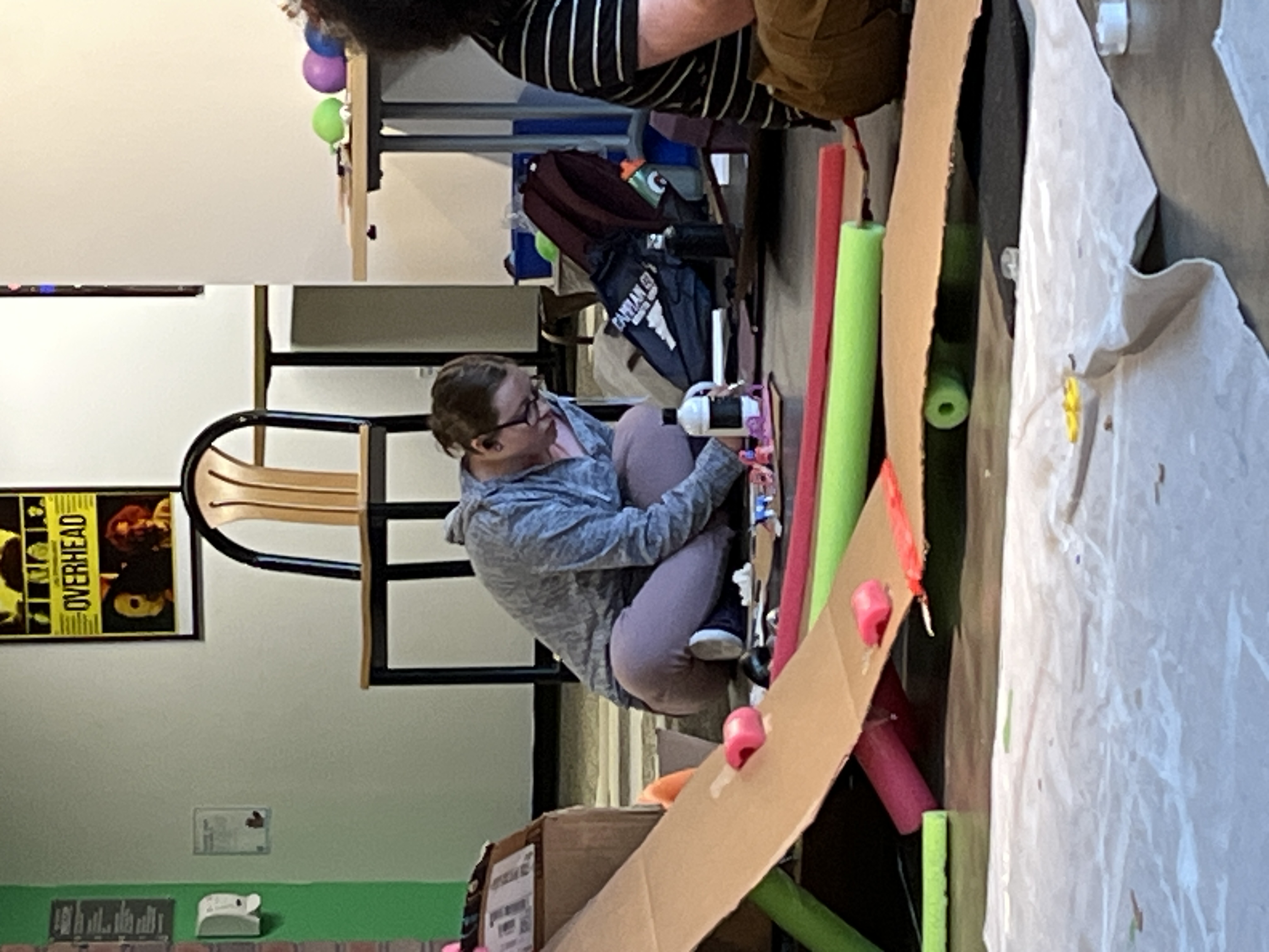 A few other cardboard designs, using cut up pool noodles. There is a girl painting designs on hers as well.