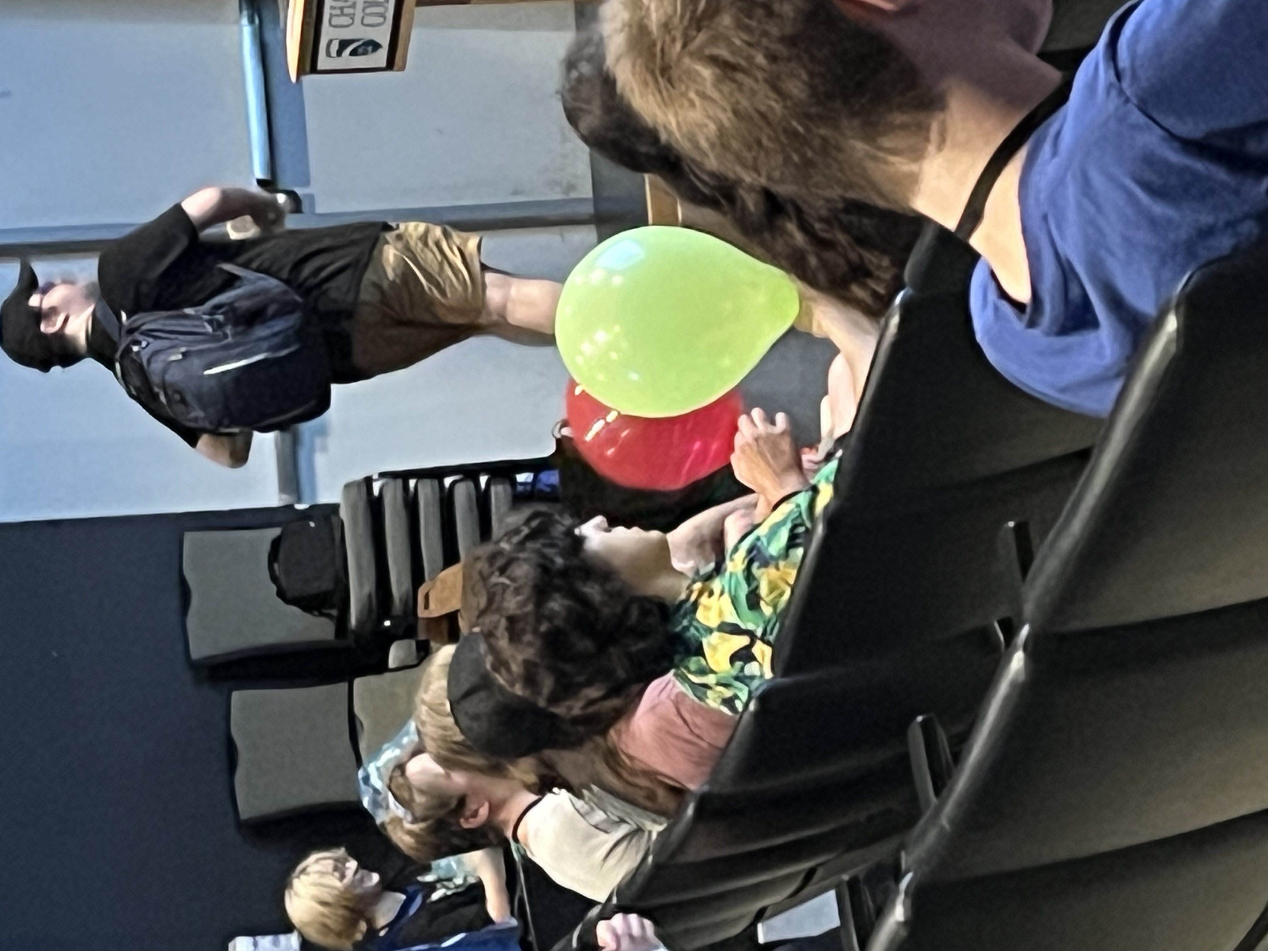 Zoomed in on a kid in a Hawaiian shirt.